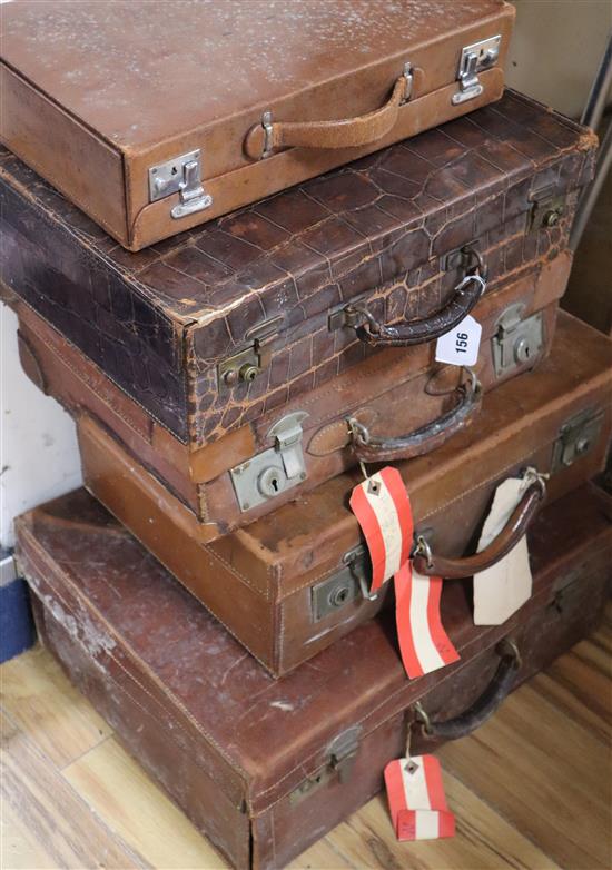 Five vintage leather suitcases largest 56cm